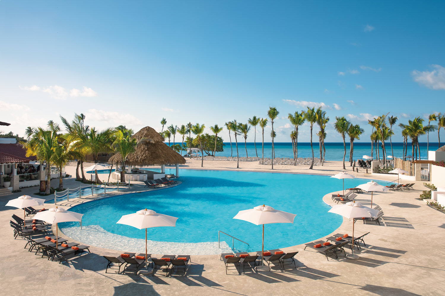 All-inclusive Caribbean resort pool lined with palm trees